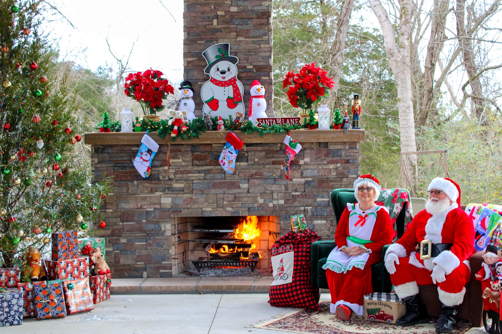 Outdoor stone fireplace decorated for Christmas at Paddle Trail