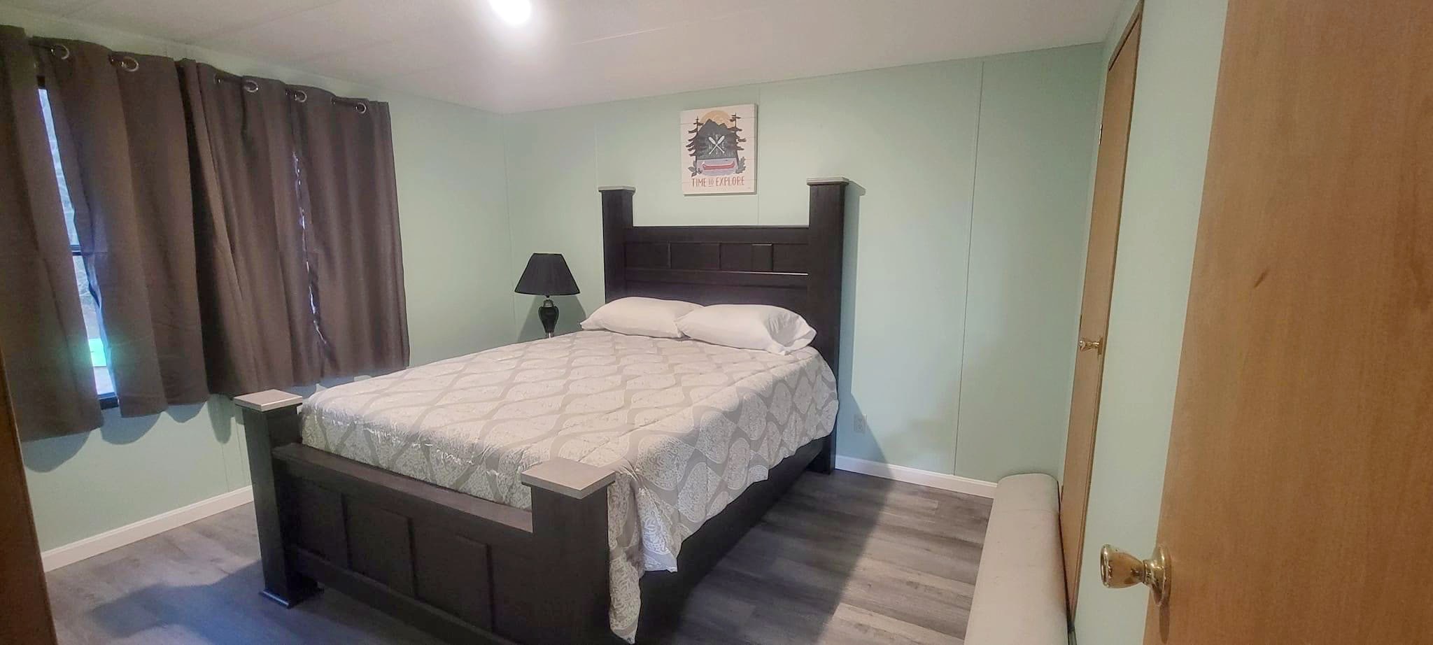 Lodge bedroom with double bed in soft morning light